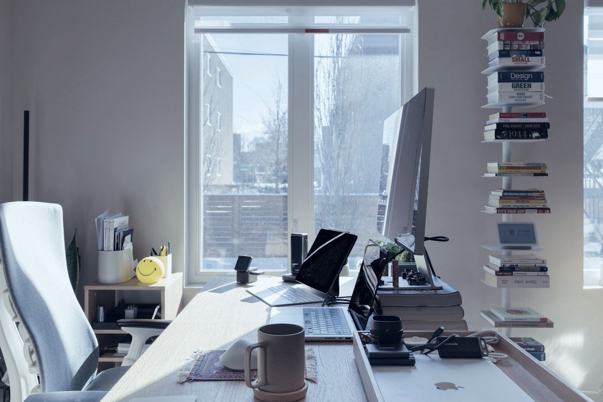 A bright home office with a large monitor.